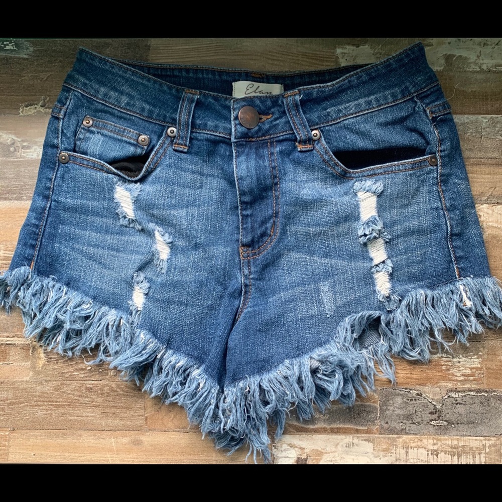 Denim shorts. Frayed bottoms.